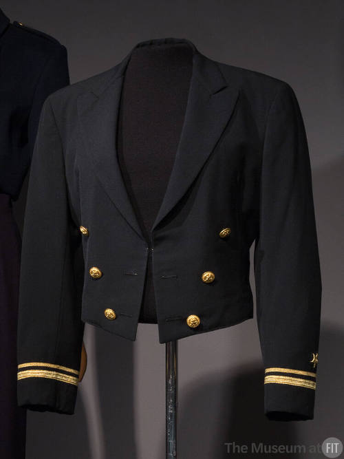 Black uniform jacket with mock double breasted front of six gold buttons and gold bands and sta…