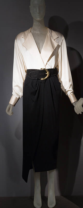 Black calf length wrap skirt with draped front and pockets, white long sleeve shirt