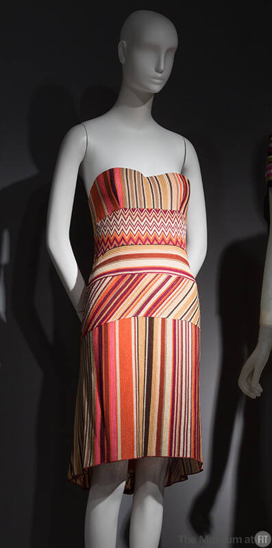 Short strapless dress with tan, fuchsia, red/purple, orange and black vertical, diagonal, horiz…