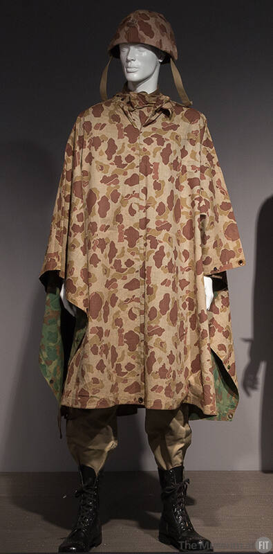 Tan and brown reversible camouflage poncho with green pattern inside