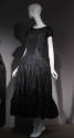 Black cap sleeve ankle length silk dress with gathered skirt and flounce hem