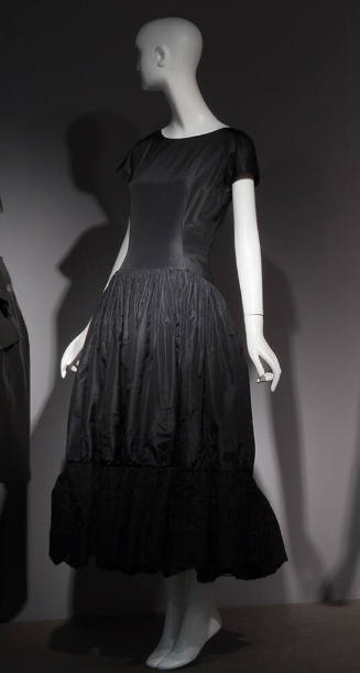 Black cap sleeve ankle length silk dress with gathered skirt and flounce hem