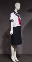 White short sleeve sailor top with blue trim and red scarf and navy blue pleated skirt