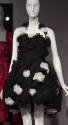 Black strapless dress with short pouf, pleated skirt and white and black flowers in overall var…