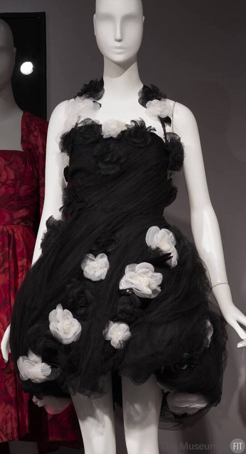 Black strapless dress with short pouf, pleated skirt and white and black flowers in overall var…