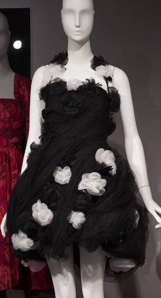 Black strapless dress with short pouf, pleated skirt and white and black flowers in overall var…
