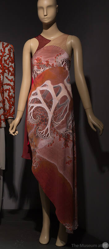 Halter neck dress with geometric print of shades of pink and red and asymmetrical hemline from …