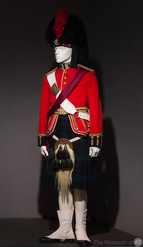 Man’s dress uniform of red jacket, green and black tartan kilt, white horsehair sporran, white …