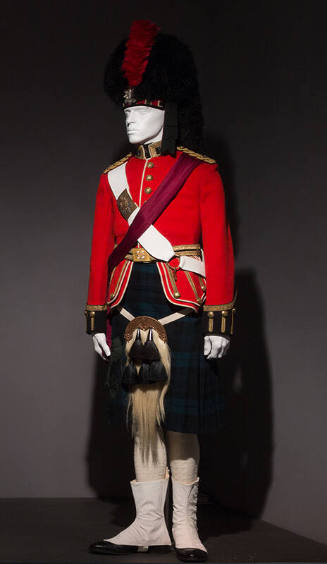 Man’s dress uniform of red jacket, green and black tartan kilt, white horsehair sporran, white …