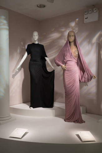 Adrian exhibition installation view of dressed mannequins on a platform
