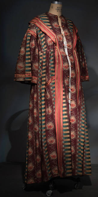 Floor length robe with alternating vertical stripes of brown floral, green and gold stripes and…