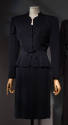 Navy blue suit:  jacket with scallop cut V-neck, shoulder pads, and below knee length straight …
