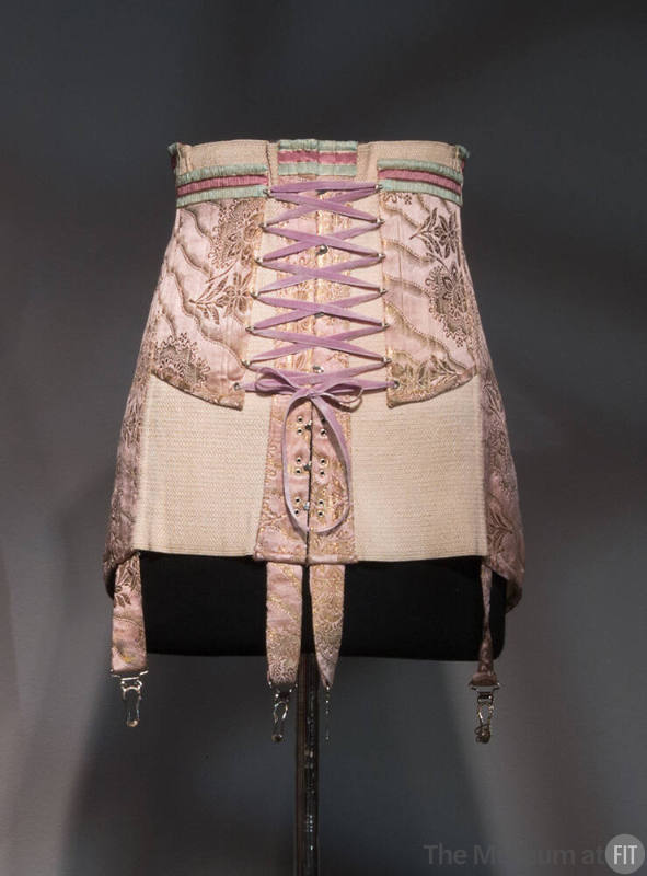 Pink girdle with gold brocade ribbon and floral motifs, elastic panels on either side, four gar…
