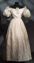 Ivory evening dress with short puff sleeves, full skirt with stitch embroidery, ribbon bows att…