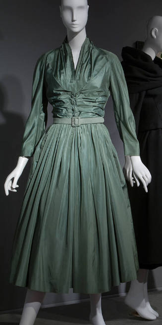 Green silk calf-length dress with stylized shirtwaist, ruching at center bodice, full skirt and…
