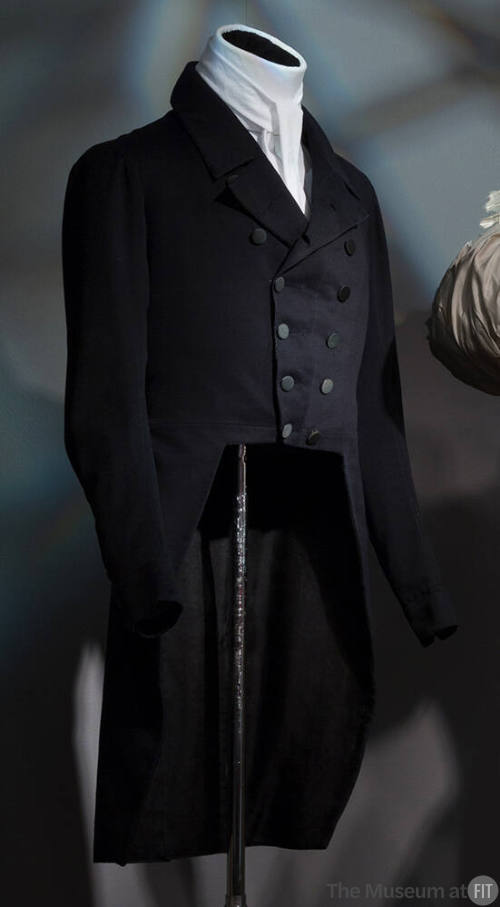 Man’s navy blue double breasted tail coat with notch collar dressed with white cravat
