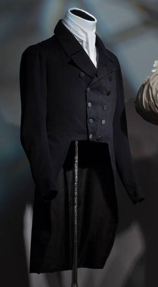 Man’s navy blue double breasted tail coat with notch collar dressed with white cravat