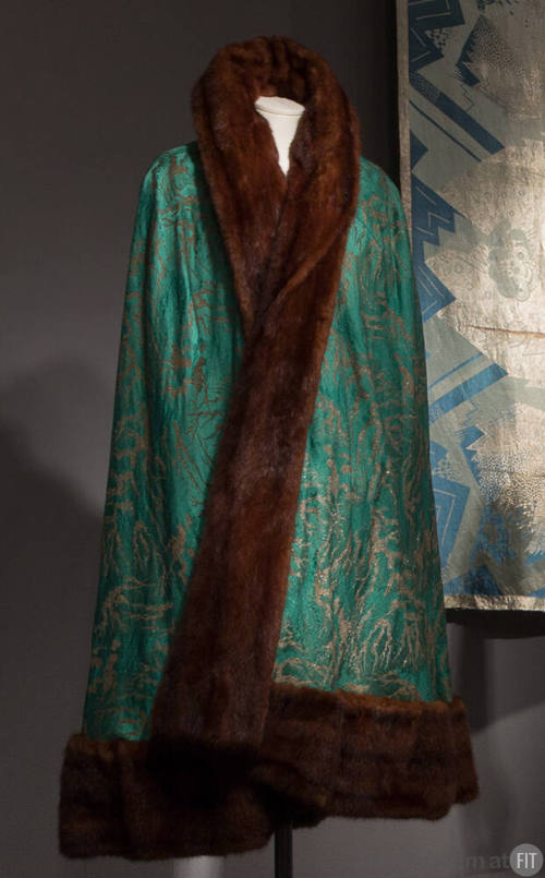 Green silk calf length cape with gold abstract brocade design and with brown fur trim