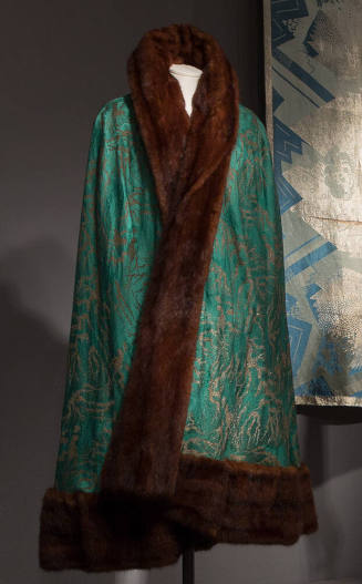 Green silk calf length cape with gold abstract brocade design and with brown fur trim