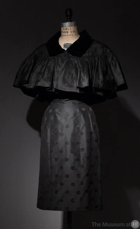 Dotted black cocktail dress and matching capelet with black velvet collar, button closure and s…
