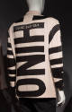 Back of taupe jacket with contrast black appliqué of oversize letters MOSCHINO placed throughou…