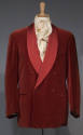 Man’s red double-breasted smoking jacket with shawl collar and two front slash waist pockets dr…
