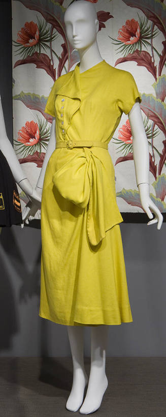 Yellow linen cap sleeve claf length dress with asymmetric button front, hip swag and matching b…