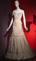 Beige strapless floor length dress with corset bodice with bue trim and gathered ruffled hem sk…
