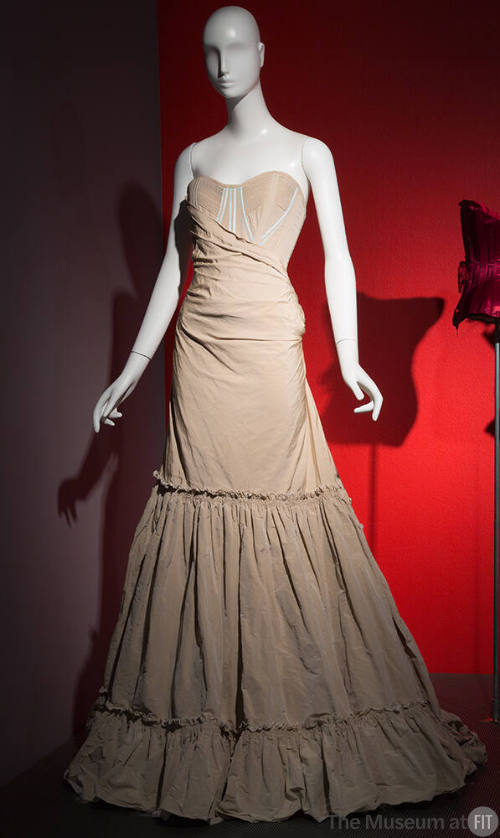 Beige strapless floor length dress with corset bodice with bue trim and gathered ruffled hem sk…