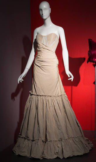 Beige strapless floor length dress with corset bodice with bue trim and gathered ruffled hem sk…