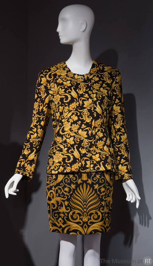 Black and gold Florentine baroque print suit with collarless jacket and straight skirt 