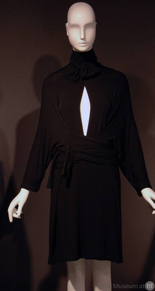 Short black pullover wrap dress, tie collar on deep slit neck, long batwing sleeves, attached w…