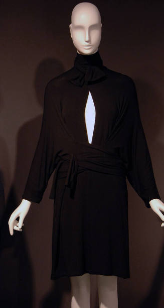 Short black pullover wrap dress, tie collar on deep slit neck, long batwing sleeves, attached w…