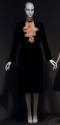 Black suit and pale pink blouse with ruffled collar 