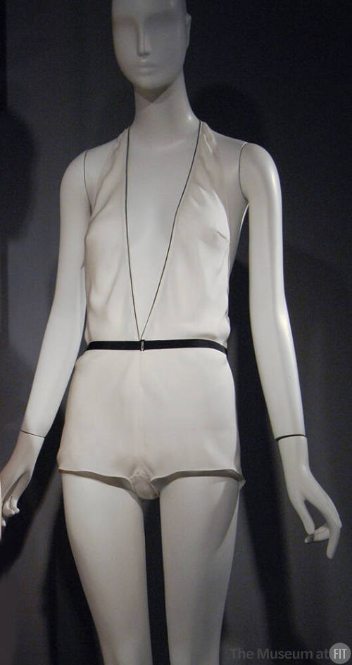 Off-white halter style boy short teddy with plunging V-neck, black edging and black ribbon belt