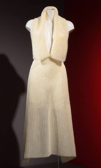 White unseamed dress shaped with 3D printed interlinked loops; square shawl collar and plunging…