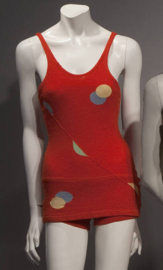 Red knit tank style swimsuit with yellow and blue appliqué circles, tank shorts