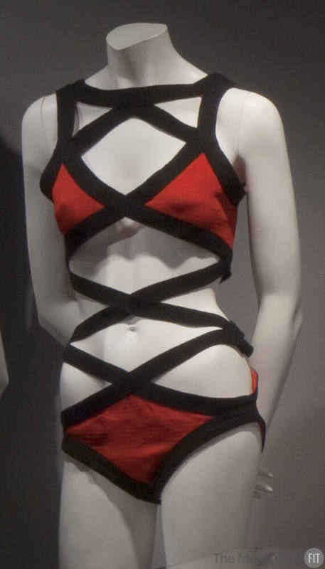 Red knit swimsuit; bra top and bikini bottom attached with black crisscross bands