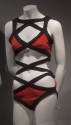 Red knit swimsuit; bra top and bikini bottom attached with black crisscross bands