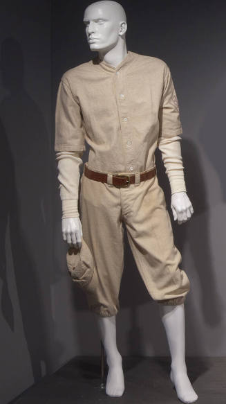 Man’s white baseball uniform of collarless elbow-length button front shirt with a long sleeve s…