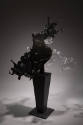 Alternate view of black and grey acrylic splash dress on a black pedestal 