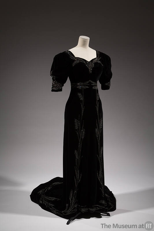 Black velvet floor-length evening gown with short sleeves, train and symmetrical pattern of sil…