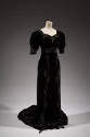 Black velvet floor-length evening gown with short sleeves, train and symmetrical pattern of sil…