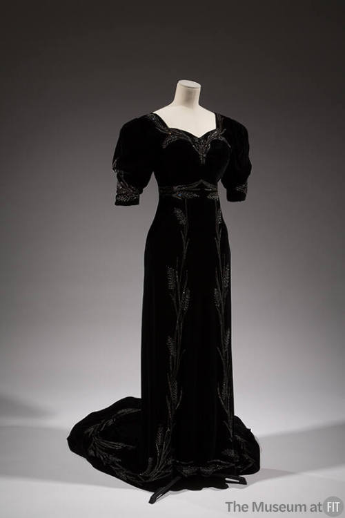 Black velvet floor-length evening gown with short sleeves, train and symmetrical pattern of sil…