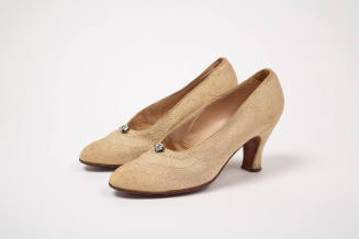 Cream faille pumps with raised wedding cake style decoration in scalloped designs; large rhines…
