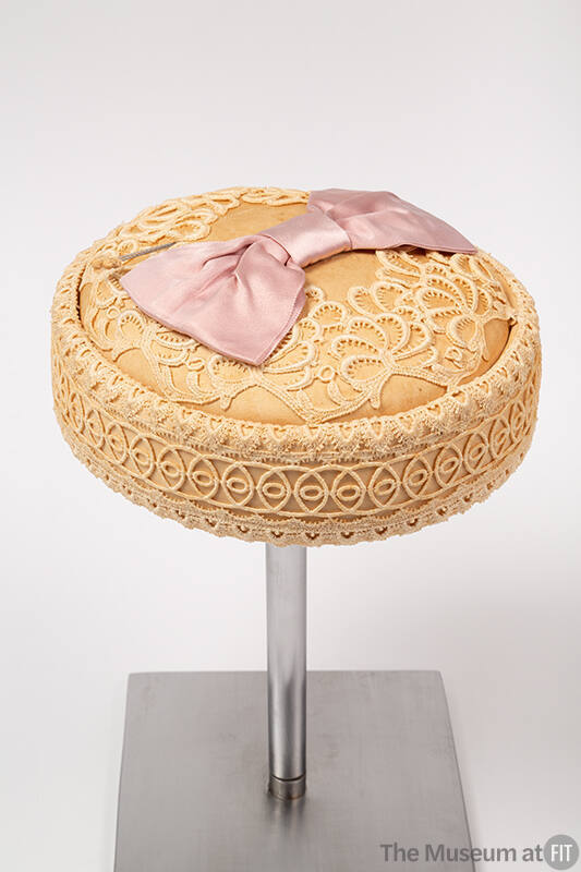 Cream venice lace pillbox hat with pink satin bow on center top