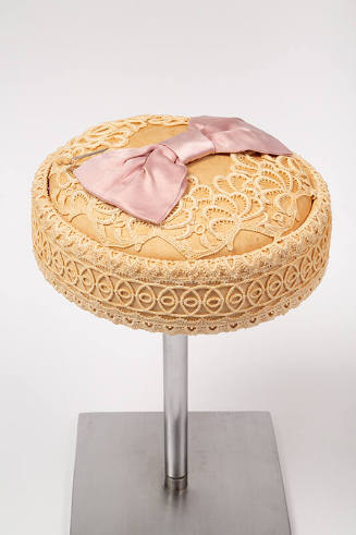 Cream venice lace pillbox hat with pink satin bow on center top