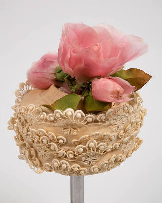 Off-white lace hat with large pink silk flower on crown 
