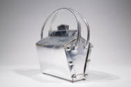 Side view of silver box shaped bag showing six round fastenings