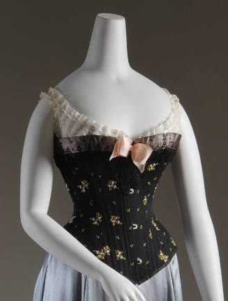 Strapless black corset with blue and green floral embroidery, black lace trim, pink bow at cent…